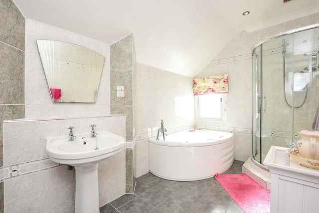The family bathroom benefits from a Jacuzzi style bath.