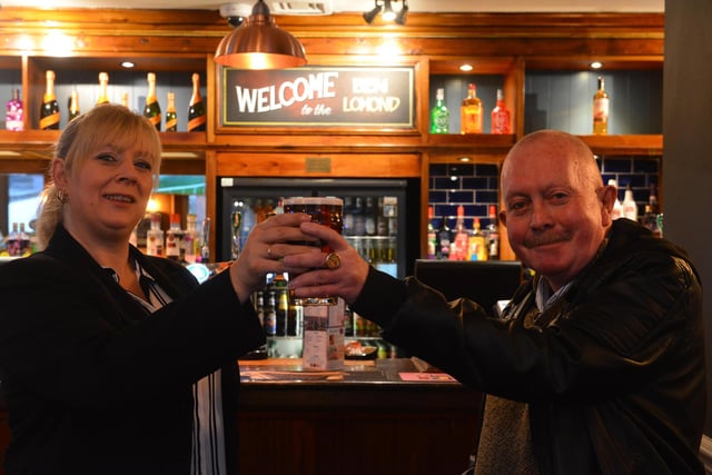 Manager Alison Eastly hands over the first drink to local customer Ken Mayne after the pub's refurbishment in 2018.