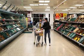 Shoppers are seen inside a Tesco store wearing face masks (Photo by Naomi Baker/Getty Images)