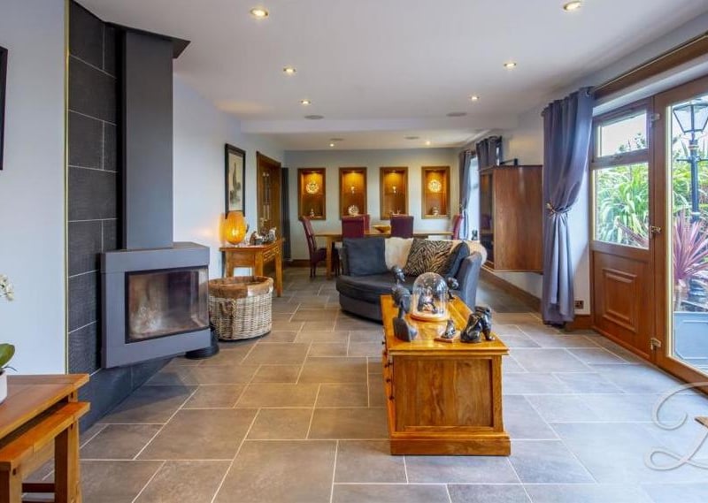 The open-plan lounge/diner, which gives a perfect first impression of the property. It boasts an array of wonderful features, including framed wall-niches and a modern fireplace.