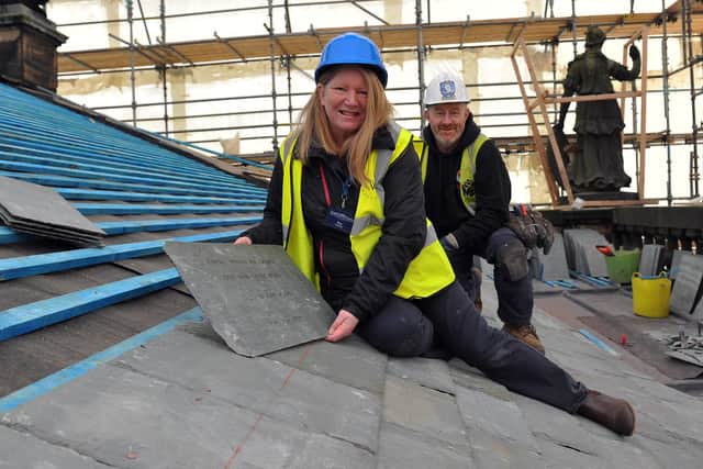 Sponsored Make Your Mark In History slates go on the East Front portico roof. Volunteer tour guide Ros Burnett is pictured with Martin Brooks roofer Dean Feethan  (Pic by Steve Mettam)