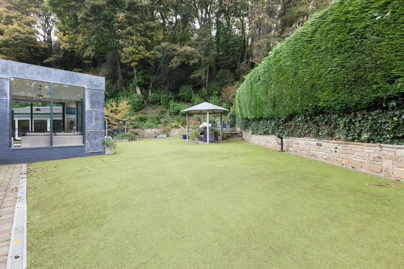 To the rear of the property, there’s a large Astroturfed lawn with exterior lighting, stone flagged seating area with a pergola over and stone steps rise to an additional stone flagged area with three sphere water features. Also, there’s a block paved area which houses the air conditioning units and access can be gained to the utility room and wash room.