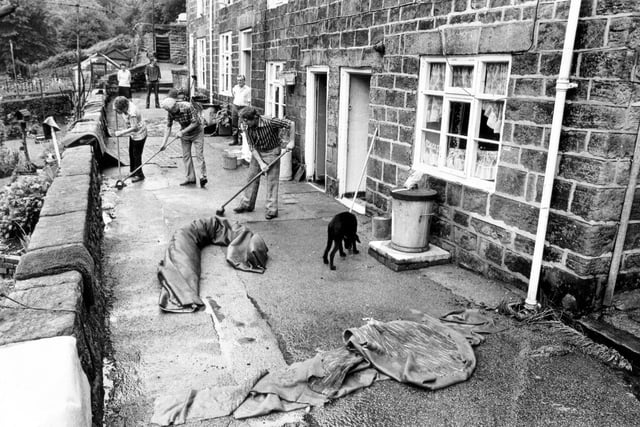 Residents mop up after flooding at Rivelin Cottages,  July 30, 1980