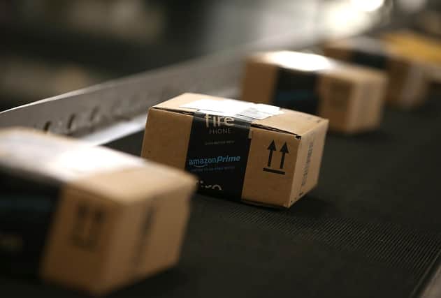 Boxes move along a conveyor belt at an Amazon fulfillment center   (Photo by Justin Sullivan/Getty Images)