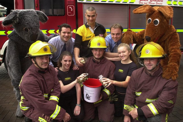 Staff from The Walkabout Bar,  Carver Street, Sheffield present £1,500 to South Yorkshire firefighters at The Central Fire Station, Wellington Street, Sheffield in 2002. The money will go towards sending South Yorkshire Firefighters to the World firefighters games . Firefighters, left to right, Stuart Hobson, Jason Jenkinson and Darren Beachell with Walkabout staff pouring the pints of pound coins.