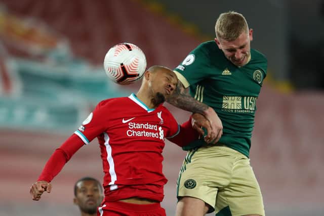 Sheffield United's Oli McBurnie (R) jumps against Liverpool's Brazilian midfielder Fabinho (Photo by MICHAEL STEELE/POOL/AFP via Getty Images)