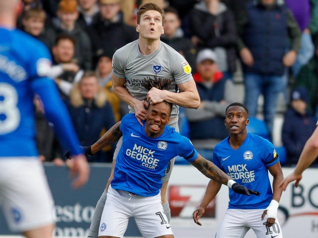 Sean Raggett challenges with Peterborough United forward Ivan Toney