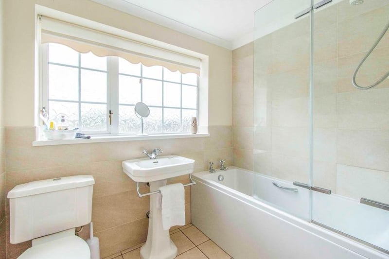 Bathroom - Fitted with a WC, a wash hand basin and a panel bath with shower over. There is a side facing obscure double glazed window, built in storage cupboard which houses the gas central heating boiler, tiling to the walls and floor and a central heating radiator.