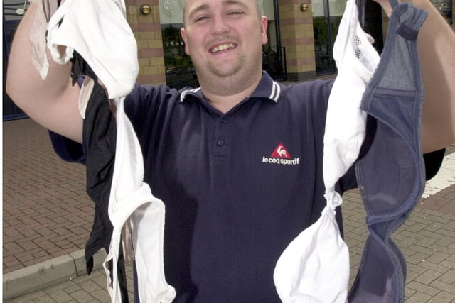 Manager Andy Flanagan with bras left behind at Brannigans bar in Valley Centertainment, Sheffield, in July 2003