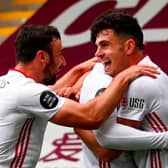 Sheffield United players celebrate with John Egan after his goal which earned the Blades a point against Burnley at Turf Moor (Photo by CLIVE BRUNSKILL/POOL/AFP via Getty Images)