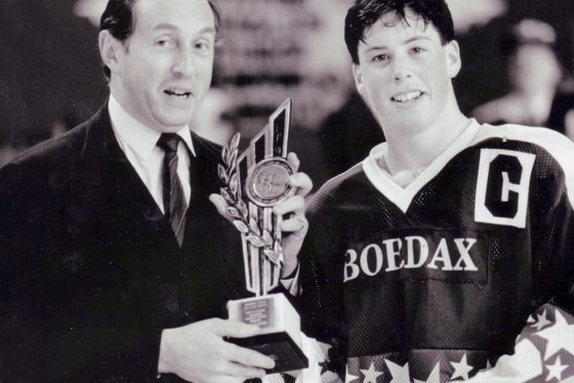 Fife Flames receive the British junior championship trophy - Richard Dingwall (right) with Frederick Meredith, chairman of the British Ice Hockey Association (BIHA), circa 1990