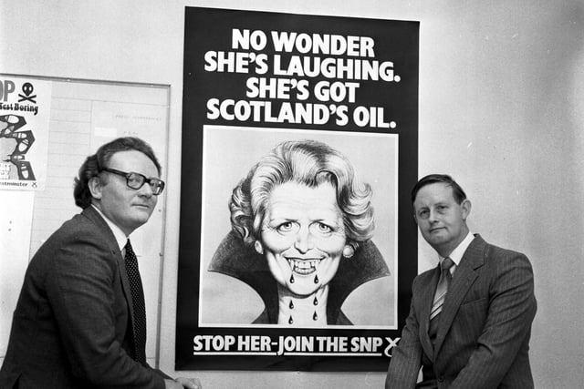 Colin Bell and (right) Gordon Wilson MP with an Scottish National Party 'recruitment' poster. The poster shows Margaret Thatcher as a vampire with the message: No wonder she's laughing. She's got Scotland's oil. Stop her - join the SNP.