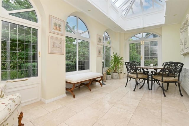 Another terrific space to relax, the orangery is bright, spacious and has double door access to the garden outside.