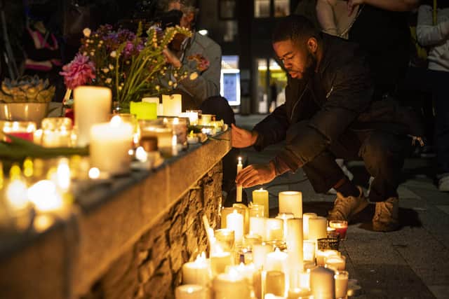 LONDON, UNITED KINGDOM â€“ SEPTEMBER 24: A man lights a candle as well-wishers gather in Pegler Square for a candlelight vigil for teacher Sabina Nessa on September 24, 2021 in London, England. Sabina Nessa, a 28-year-old primary school teacher, was found dead in Cator Park in Kidbrooke, south-east London by a member of the public on Saturday 18 September. She was on her way to meet someone and just five minutes from home. Police have arrested a 38-year-old man in connection with the killing. (Photo by Rob Pinney/Getty Images)