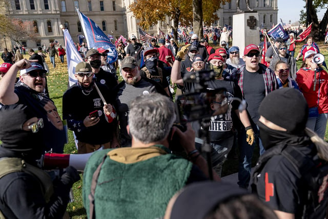 Trump supporters, rear, demonstrating the election results, argue with counter protestors at the State Capitol in Lansing, Mich (AP Photo/David Goldman)