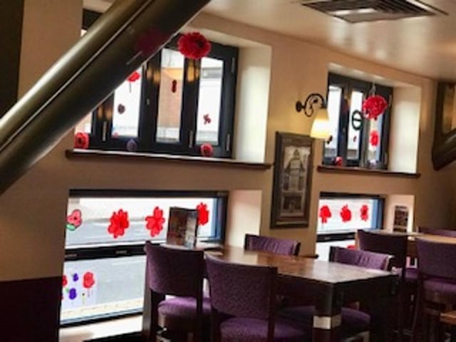 Diners are surrounded by beautiful handmade poppies