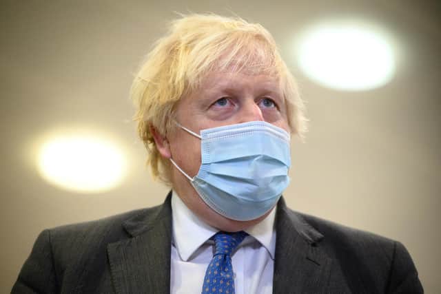 RAMSGATE, UNITED KINGDOM - DECEMBER 16: Britain's Prime Minister Boris Johnson speaks with the media during a visit to an NHS Covid-19 vaccination centre on December 16, 2021 near Ramsgate, United Kingdom. The Government is pushing the booster jab program as the country recorded its highest number of daily infections since the pandemic began. England's chief medical officer Professor Chris Whitty has warned that more Covid records will be broken as the Omicron variant spreads further. (Photo by Leon Neal - WPA Pool/Getty Images)