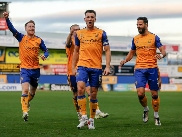 Mansfield Town midfielder Ollie Clarke celebrates scoring.