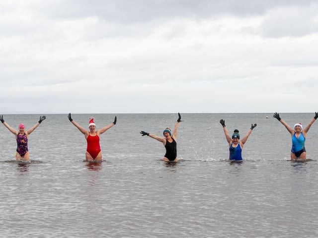 Elaine Mcohrie, Isabella McNamara, Kirsteen Barr-Kearsey, Marie Rudd and Jo Mellish from Wild Swim Scotland proudly posing after making it into Porty's waters despite the freezing weather.