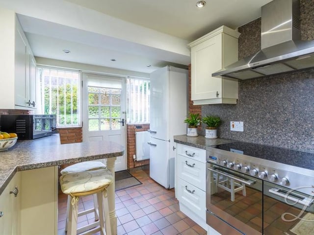A second view of the kitchen, showing the oven and door to the garden. As you can see, there is plenty of worktop space.
