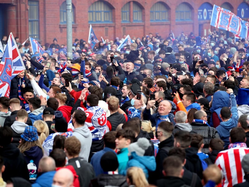 Rangers fans celebrate outside of the Ibrox Stadium after Rangers win the Scottish Premiership title.