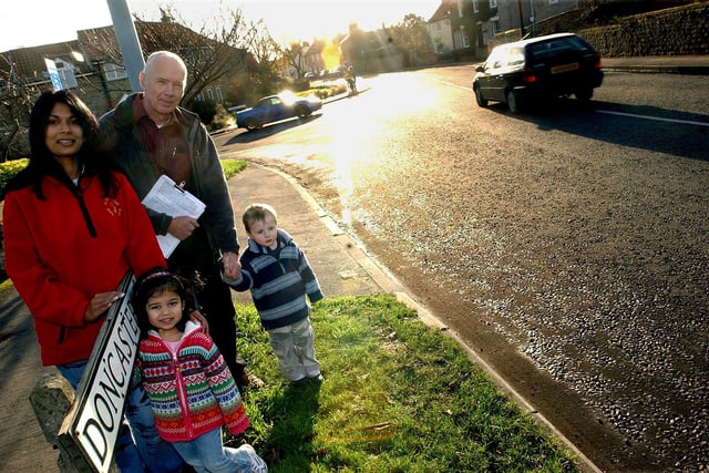 Back in 2004 Graham Fox, of Common Lane, Tickhill, is pictured with a petitiion asking for road safety measures to be introduced on Doncaster Road. Looking on is Sue Draper, of the Wilsic Road Day Nursery, and her daughter Isabella Draper, aged three, and Ben Whitaker, also aged three. Sue has to cross Doncaster Road, and contend with the traffic, with children who attend her nursery.