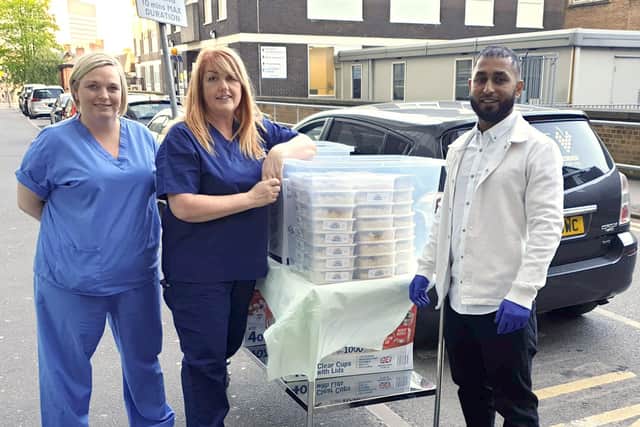 Staff at Sheffield's Royal Hallamshire Hospital accepting delivery of food on Wednesday evening from the The Vine in Mosborough as part of National Curry Week for Health Heroes, organised by the food ordering platform ChefOnline. Photo: PA Wire