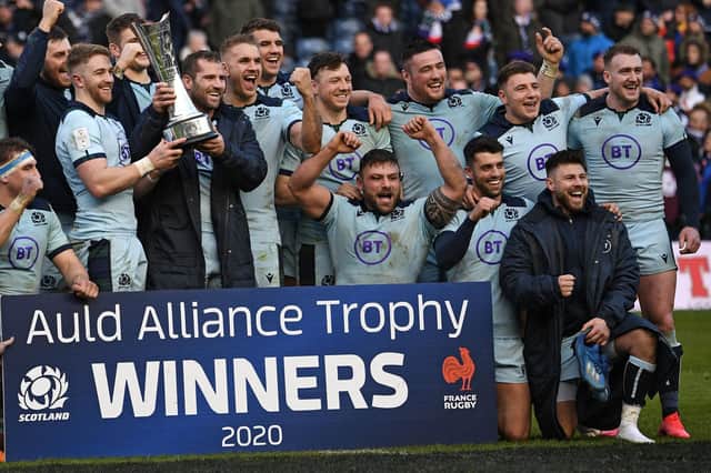 Scotland players including Stuart Hogg, back far right, and Rory Sutherland, third from right at front, celebrating with the Auld Alliance Trophy after beating France 28-17 in Edinburgh a year ago (Photo by Anne-Christine Poujoulat/AFP via Getty Images)