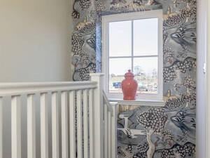 Staircase featuring tapestry inspired paper.