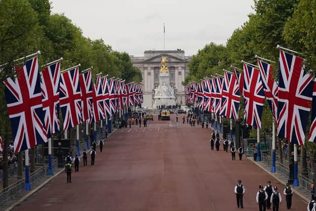 Crowds gather along The Mall ahead of the ceremonial procession of the coffin of Queen Elizabeth II from Buckingham Palace to Westminster Hall, London. Victoria Jones/PA Wire