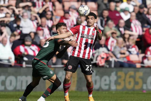 Morgan Gibbs-White of Sheffield United is tackled by Matty Wolfe of Barnsley: Andrew Yates / Sportimage