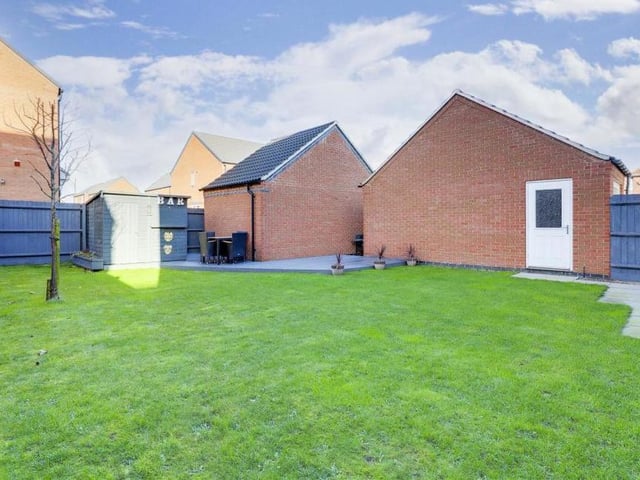 A second view of the back garden, which has lots of scope and potential. It also features courtesy lighting and an outdoor tap, and is surrounded by panelled fencing.