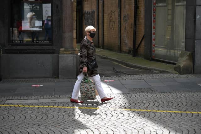 A shopper wears a face mask in the centre of Sheffield  (Photo by Oli SCARFF / AFP) (Photo by OLI SCARFF/AFP via Getty Images)