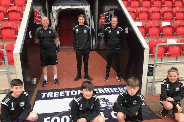 Treeton Terriers chairman James Billson (back row, right) and Rotherham's head of academy recruitment, Scott Duncanson, with some Treeton Terriers youngsters.