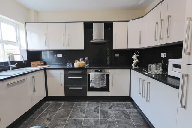 This fully fitted kitchen is light and bright, with lots of storage space.