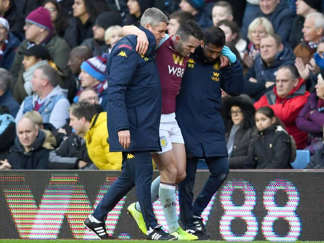 John McGinn of Aston Villa is helped off the pitch after picking up an injury during the Premier League match between Aston Villa and Southampton FC at Villa Park on December 21, 2019 in Birmingham, United Kingdom. (Photo by Clive Mason/Getty Images)
