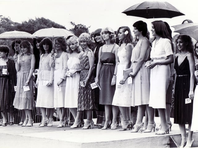 Our picture shows competitors in the Miss Motor Show contest standing in the rain at the Sheffield Motor Show and Family Gala, Graves Park, Sheffield, July 18, 1981