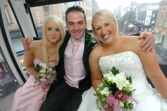 Joe and Kaz Tully from Killamarsh, who took a trip on the big wheel in Fargate after getting married in August 2009 at Sheffield Town Hall, with bridesmaid Jace Beachell