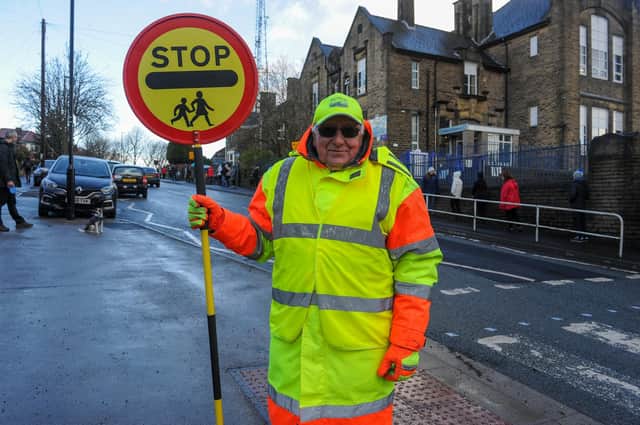 Seventy four year old Eddy Parton taking control of the crossing at Lydgate Lane School