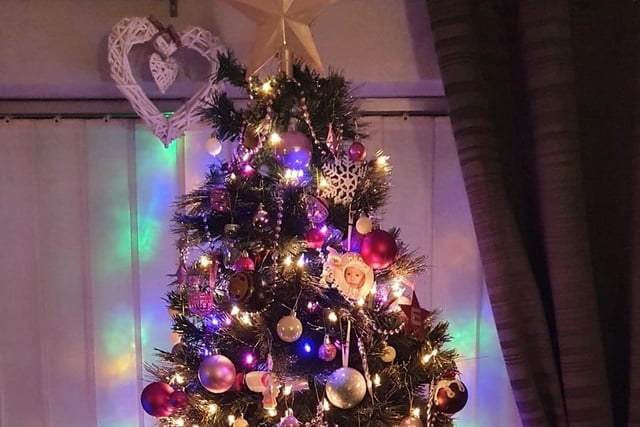 The tree in Amanda Draper Hadfield's photo is almost as tall as the room and is laden with pretty decorations.