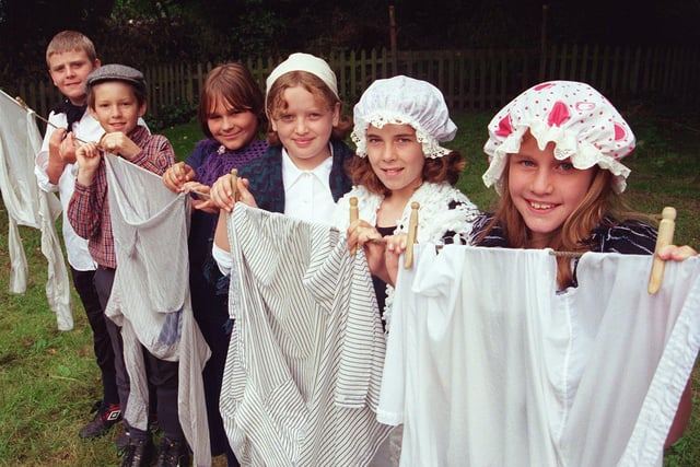 Children from the Emmanuel Junior school, Waterthorpe are seen hanging out the washing during their visit to the hamlet in 1999