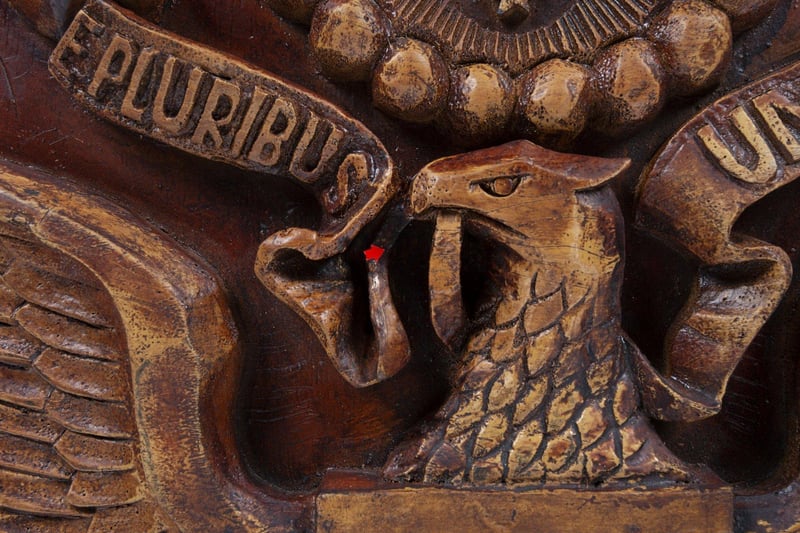 A wooden reproduction of the carved American Great Seal plaque which was gifted to the American ambassador to Russia in 1945 by the Soviet Boy Scouts, and which contained a hidden microphone listening device or "bug." The discovery was kept secret for years by the US until tensions between the two superpowers exploded in the media after an American U2 spy plane was shot down over Russia in 1960. As a rebuttal to Russian claims that the US was spying on them the plaque and it's hidden microphone (aka The Thing) was revealed during corresponding court proceedings.