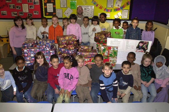 Pictured at Netherthorpe Primary School, Sheffield in 2003, where pupils have been filling shoe boxes that will be sent to Eastern Europe for Christmas. Seen is Mr Paul Ryalls from Mission Ministries and teacher Chantelle Wharry, with pupils and the boxes.