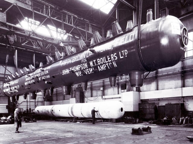 A giant drum is suspended in the crane during loading operations at the Atlas Works of Firth Brown Limited, Sheffield.