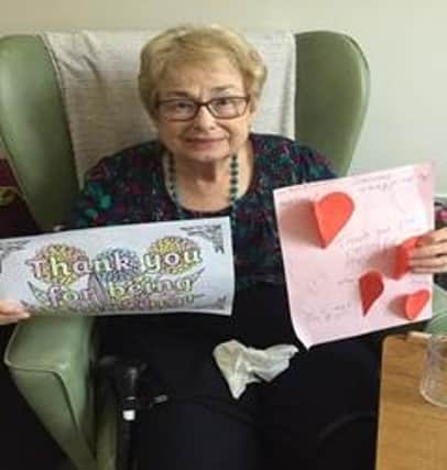 Ann Curbishley, who lives at Twelve Trees Care, holding up the letters children sent in.