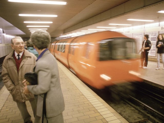 A couple chatting in Buchanan Street underground station in Glasgow as the train comes in, August 1990.