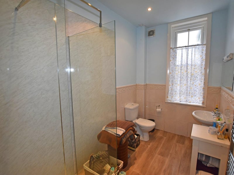 The shower room measures 11ft 10in by 6ft.