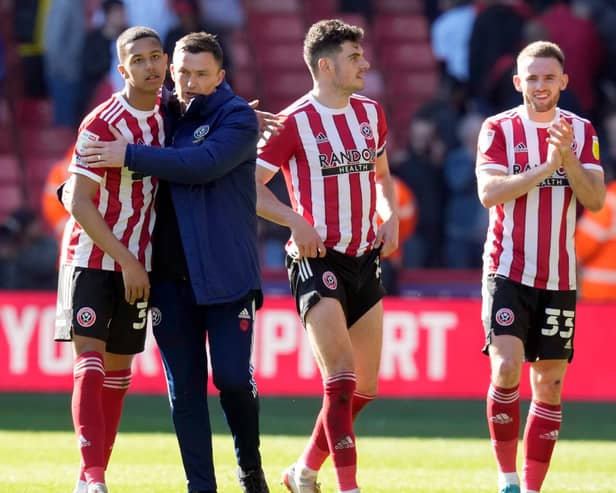 Kyron Gordon is hugged by Paul Heckingbottom after Sheffield United's victory over Barnsley at Bramall Lane: Andrew Yates / Sportimage