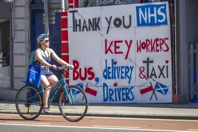 A woman cycles past a poster thanking the NHS and key workers in Edinburgh, as Scotland moves into phase one of the Scottish Government's plan for gradually lifting lockdown. Photo: Jane Barlow/PA Wire