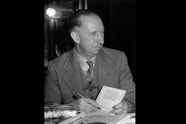 11th May 1953:  English novelist Nevil Shute (1899 - 1960) autographing books in aid of the National Fund for Polio Research at Harrod's Book Department.  (Photo by Central Press/Getty Images)